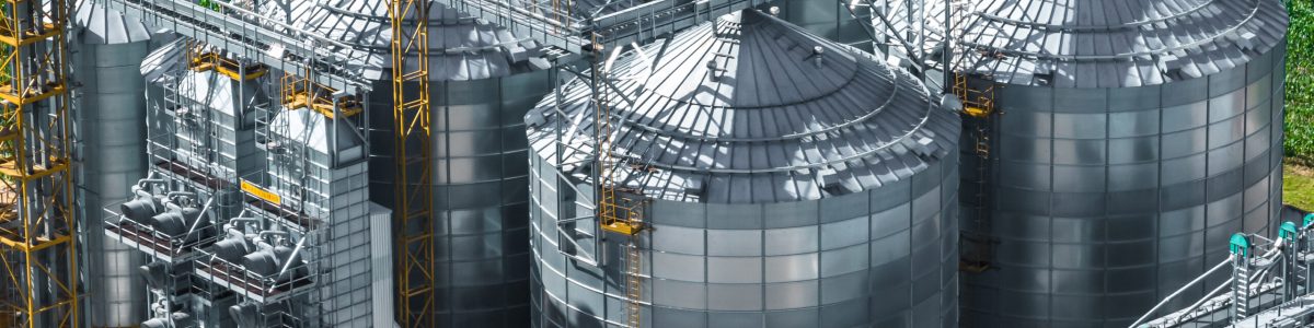 aerial view on agro silos granary elevator on agro-processing manufacturing plant for processing drying cleaning and storage of agricultural products, flour, cereals and grain.