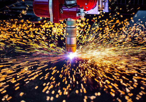 CNC Laser plasma cutting of metal, modern industrial technology. Small depth of field. Warning - authentic shooting in challenging conditions. A little bit grain and maybe blurred.